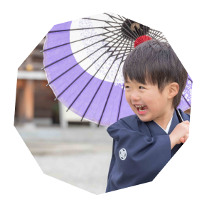 傘を持ち笑顔で楽しそうにしている男の子